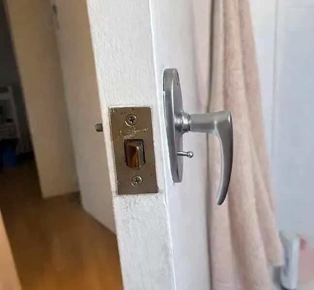 A bathroom door with an old lever latch, before the privacy mortice
